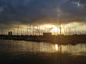 Sailboats in marina at sunset