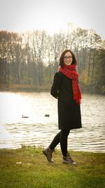 Woman standing by lake