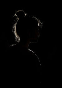 Portrait of woman in black background