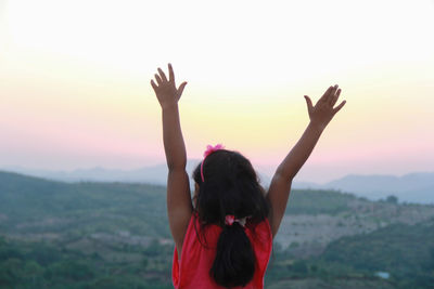 Silhouette of woman standing against sky