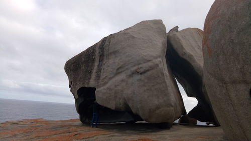 Close-up of rock by sea against sky