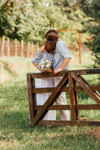 Rear view of woman with umbrella on field