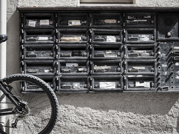 Bicycle parked in front of letterboxes