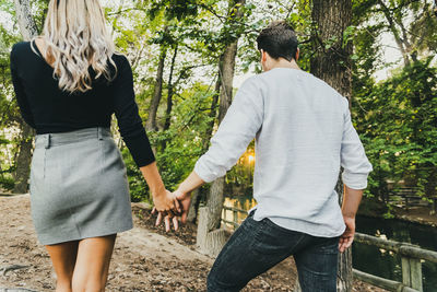 Rear view of couple walking in park