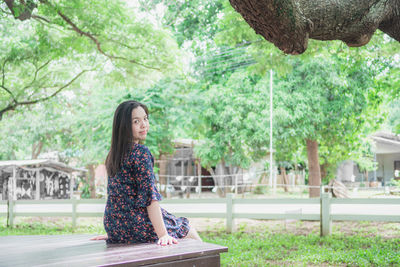 Portrait of woman sitting in park