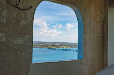 Scenic view of sea against sky seen through window