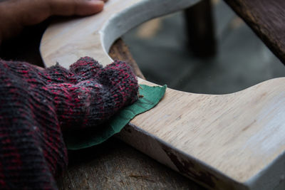 Close-up of hand holding wood