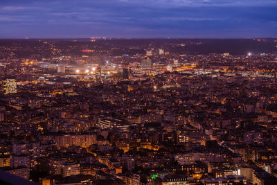 High angle view of illuminated cityscape against sky at night