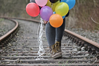 Low section of woman with balloons