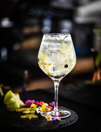 Tonic gin beverage with fresh fruits and spices