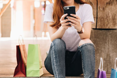 Midsection of woman using mobile phone