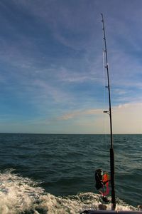 Man standing in sea against sky