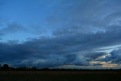 Scenic view of field against sky at dusk