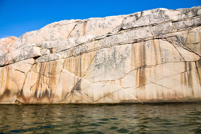 Rock formations by sea against sky