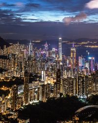 Illuminated cityscape against sky at night