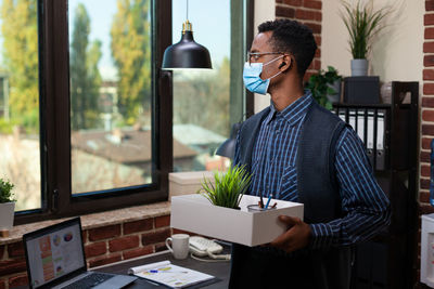 Businessman holding box in office