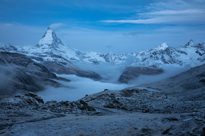 Scenic view of snowcapped mountains against sky