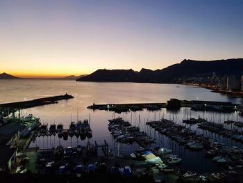 High angle view of sailboats in sea at sunset