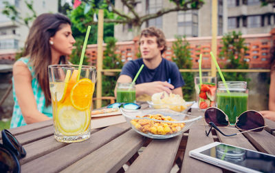 Friends having food and drink at restaurant