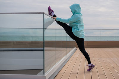 Low section of woman exercising in gym