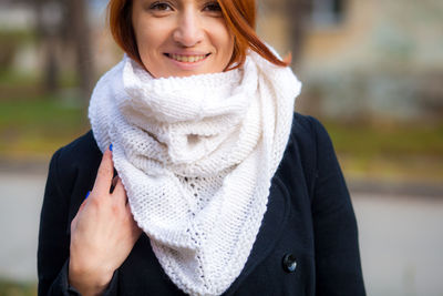 Close-up portrait of a smiling young woman during winter