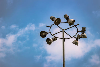 Low angle view of telephone pole against sky