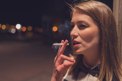 Close-up of woman smoking cigarette