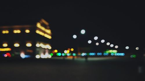 Defocused image of illuminated city at night