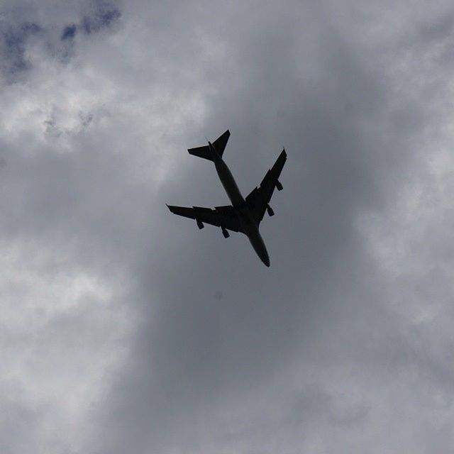 flying, low angle view, airplane, mid-air, air vehicle, sky, transportation, cloud - sky, mode of transport, cloudy, on the move, cloud, spread wings, travel, motion, public transportation, outdoors, day, flight, helicopter