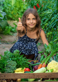 Portrait of smiling young woman holding vegetables