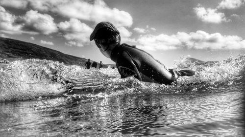 Side view of surfer in sea