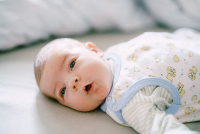 Close-up of cute baby boy sleeping on bed at home