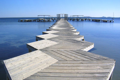 Wooden jetty leading to sea