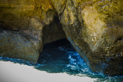 Scenic view of sea seen through cave