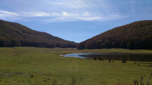 Scenic view of lake and mountains against sky