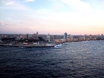 Sea and cityscape against sky