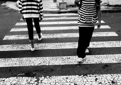 Low section of woman standing on footpath