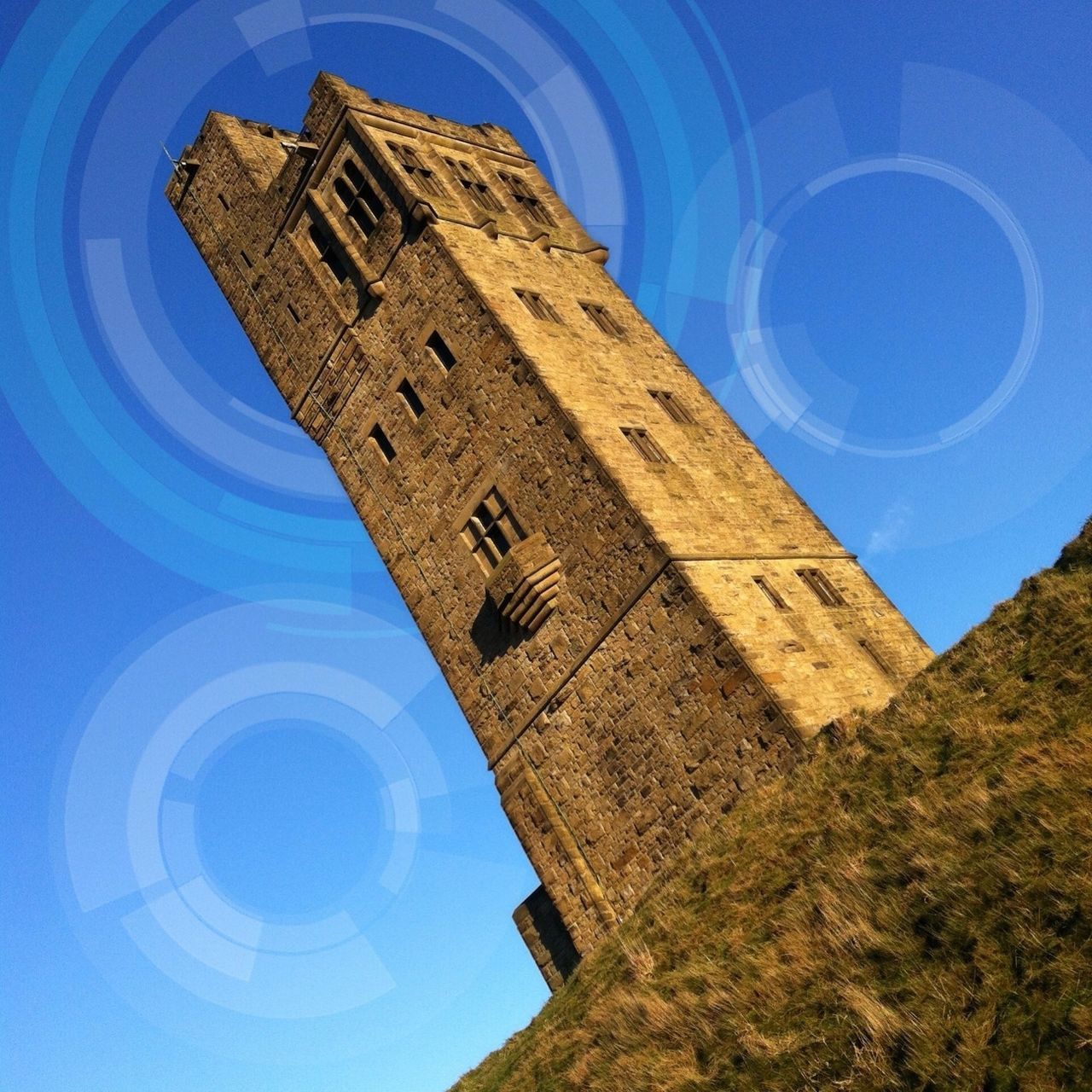 blue, architecture, built structure, low angle view, building exterior, sky, circle, sunlight, reflection, no people, day, outdoors, geometric shape, history, clear sky, fish-eye lens, building, tower, window, arch