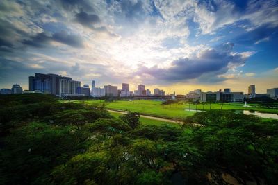 View of cityscape against cloudy sky