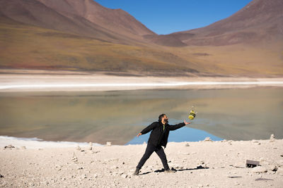 Bolivia desert altiplano man playing with hat