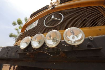 Low angle view of old vintage car against sky