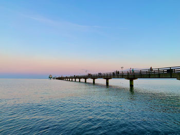 Pier on sea against clear sky