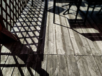 High angle view of shadow on tiled floor