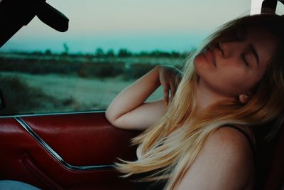 Portrait of woman sitting in car