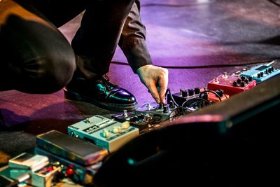 Close-up of man playing guitar