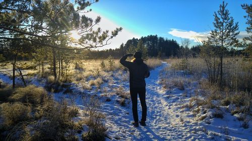 Full length of man standing on snow covered field