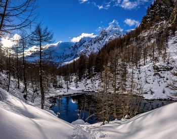 Scenic view of snow covered mountains against sky