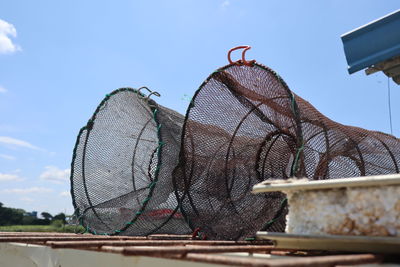 Low angle view of fishing net against sky