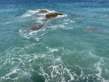 Rocky beach and crystal turquoise water of ionian sea in albania.