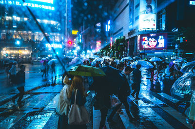 Crowd on street in city at night